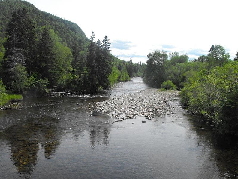 Hughes Brook river bordered by forested hills in Newfoundland and Labrador.