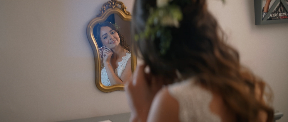 bride looking in mirror.png
