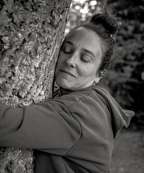 Anne-Marie hugging a tree.