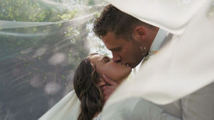 a groom kissing his new bride
