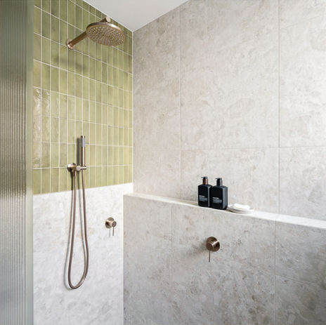 Modern shower with olive tile and marble