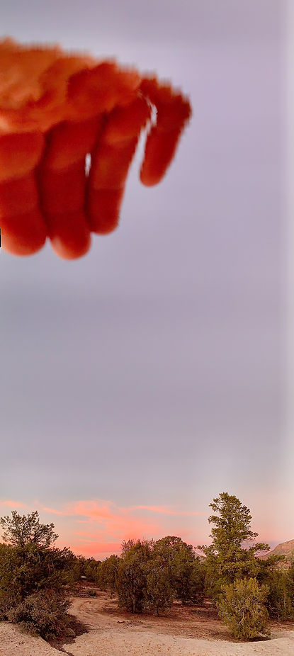 Distorted abstract Land Skein photograph by David Deighton using panoramic mode on iphone on artist's hand over the desert sunset