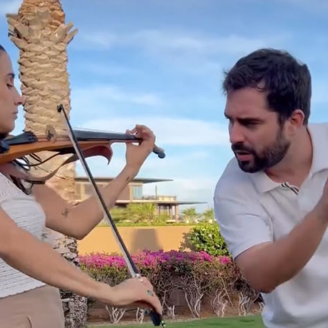 Live violin and cello duo performing cocktail hour music at Los Cabos wedding.
