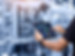 Smart industry control concept.Hands holding tablet on blurred automation machine as backg