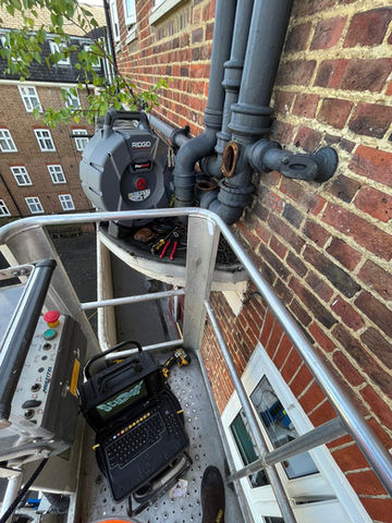drainage service equipment high up outside block of flats