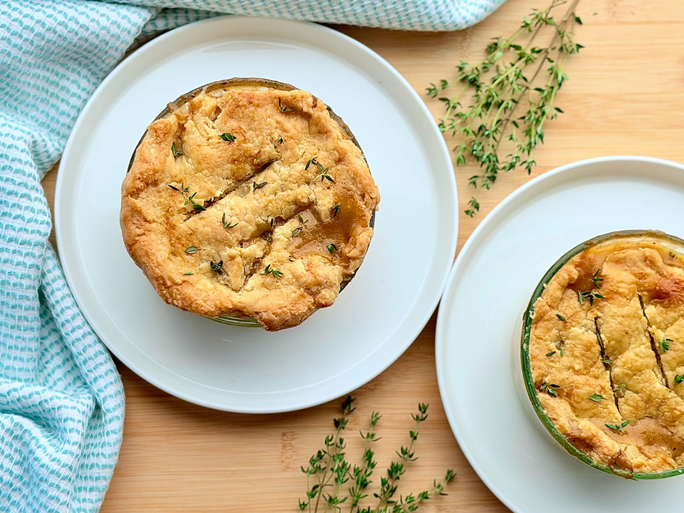 Individual gluten free dairy free chicken pot pies baked in white ceramic ramekins with golden brown pastry crusts.