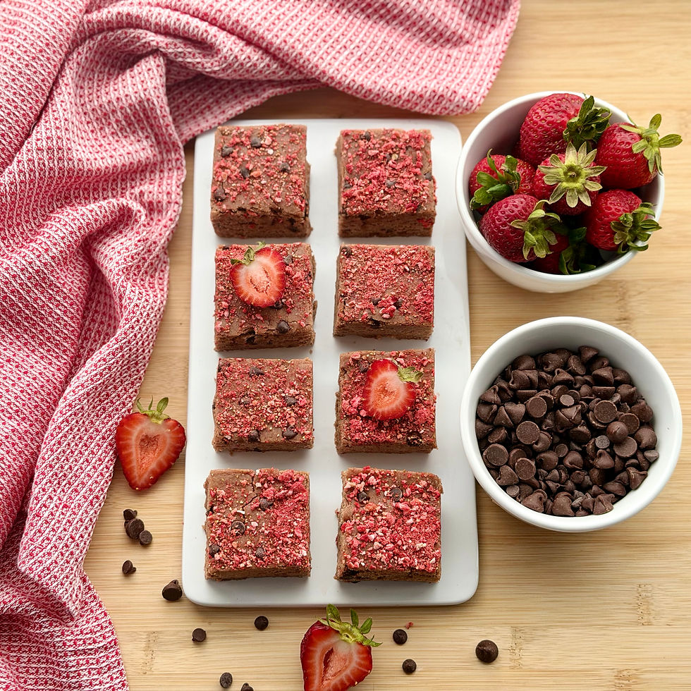 No-Bake Chocolate Chip PB&J Protein Bars on a White Platter with Chocolate Chips and Strawberries