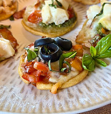 a mini chickpea pizza with tomatoes, basil and olives 