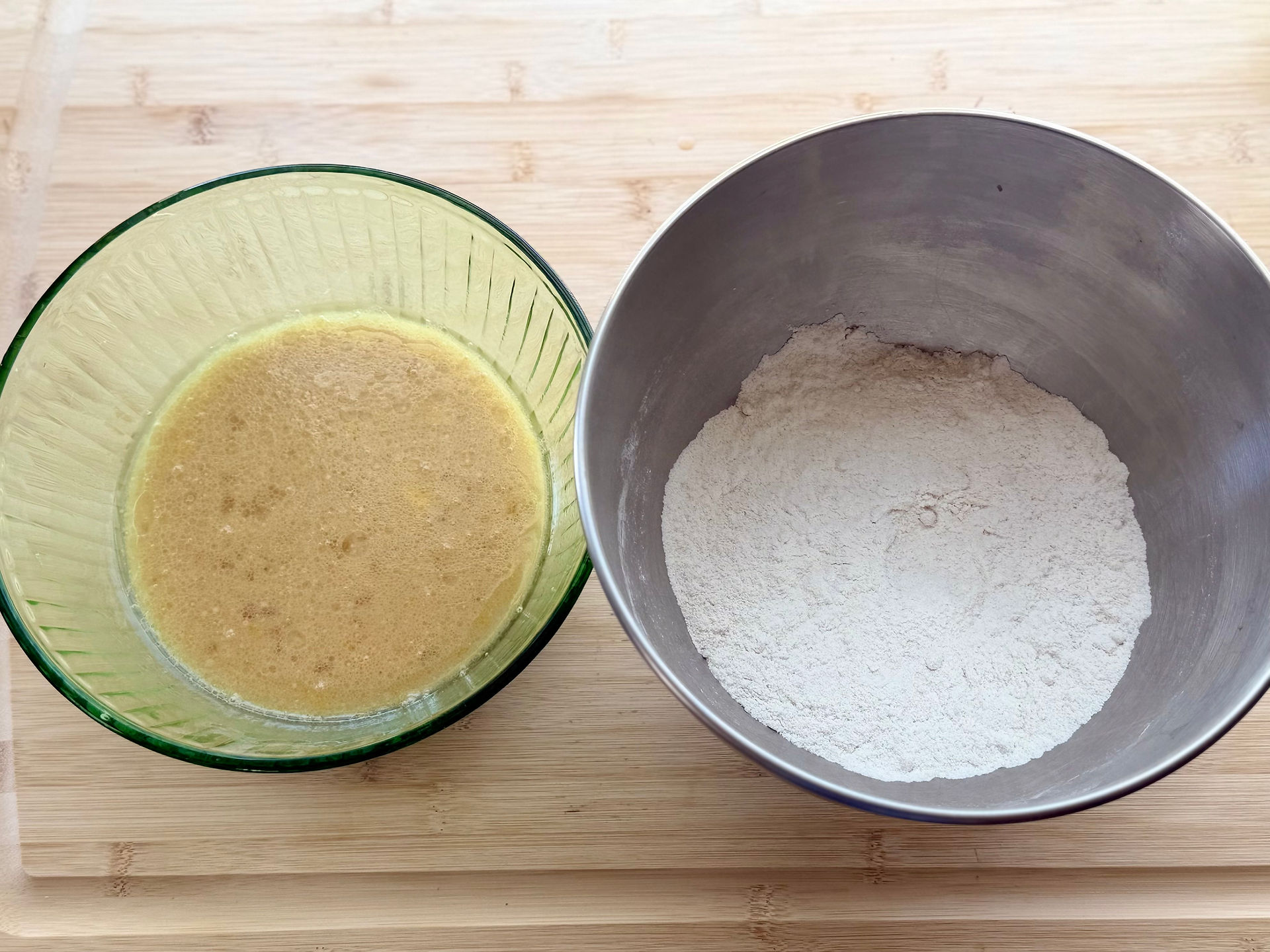 Wet ingredients and dry ingredients in bowls for cinnamon swirl muffin batter