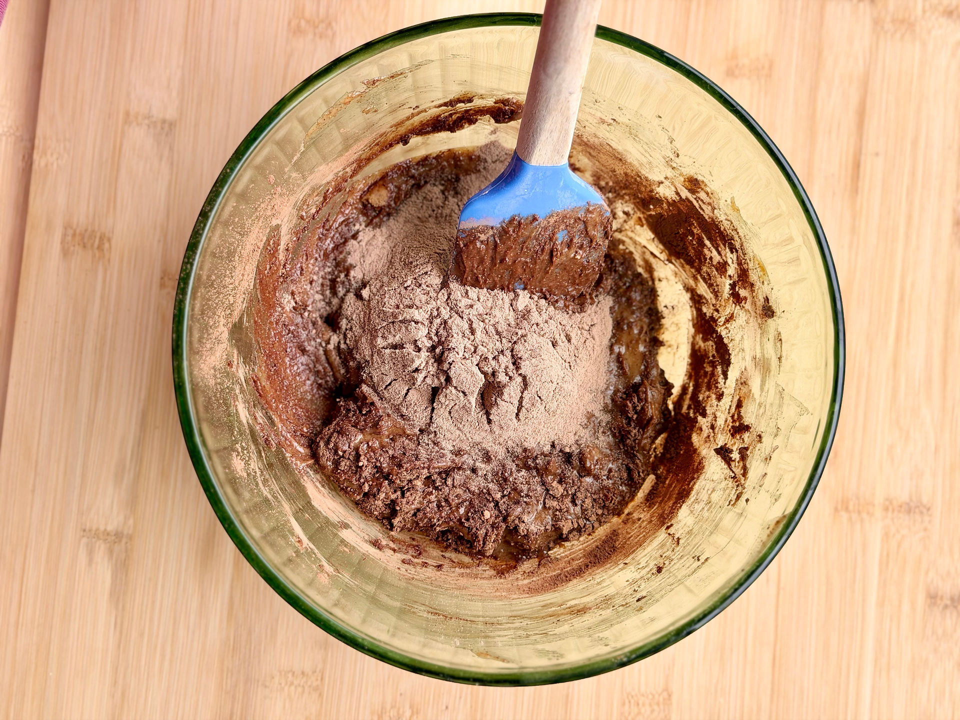 protein powder and cocoa powder in bowl with wet ingredients