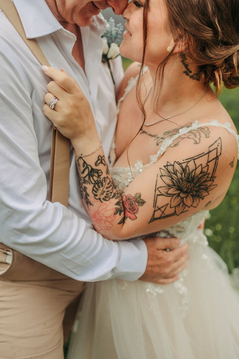 A couple gets married on Fernie Alpine Resort and does their wedding photos in Fernie, BC on a bridge in the ski hill, the photo shows their torsos up close