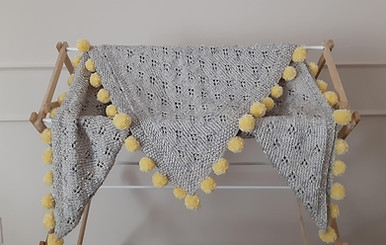 Nest Collection: lacy knit baby blanket with pom pom edging