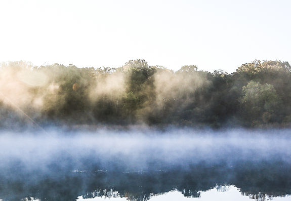 Man on a dock at sunrise