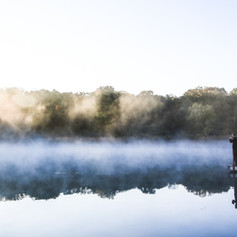 Man on a dock at sunrise