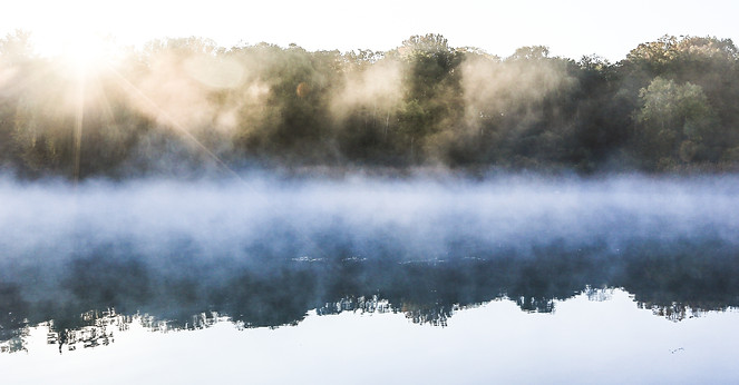 Man on a dock at sunrise