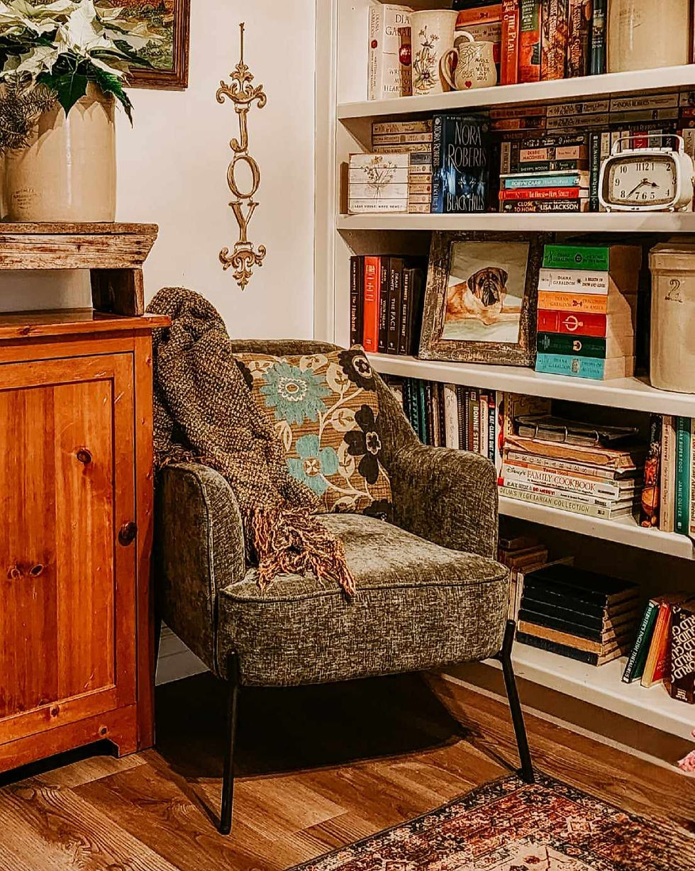 A green chenille armchair reading nook.