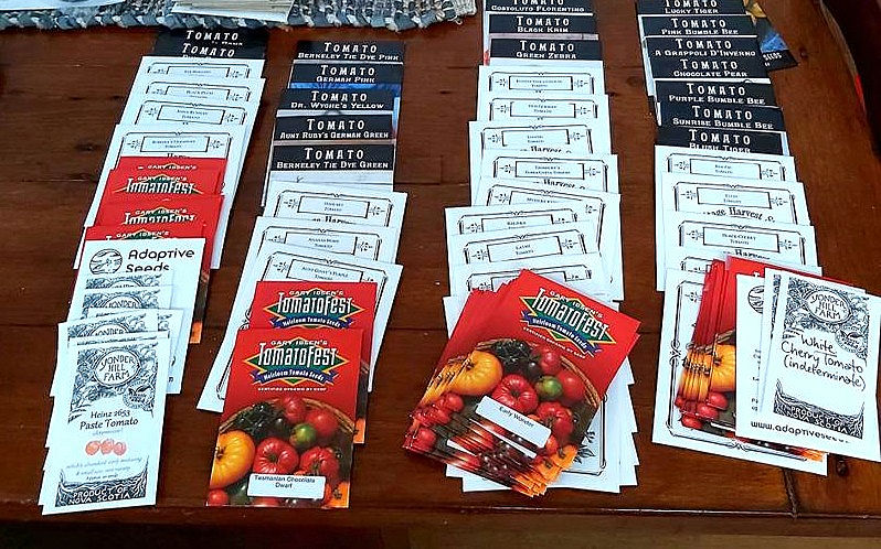 Rows of seed packages laid out on a table. 