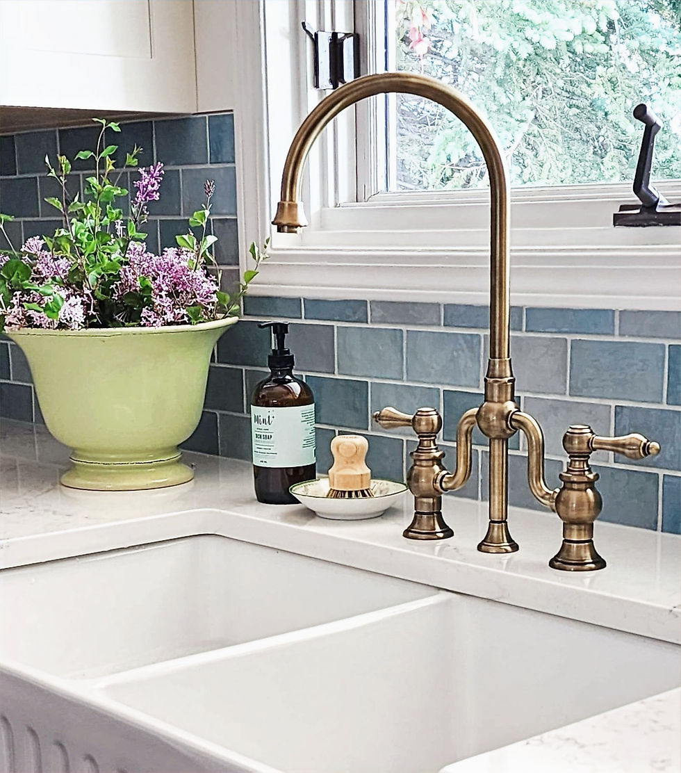Backsplash in varying shades of blue and a gorgeous brass faucet.