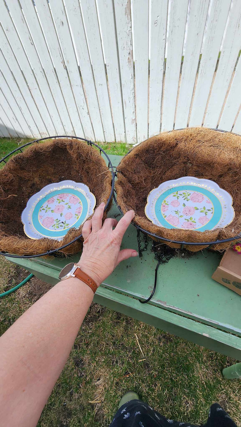 Paper plates at the bottom of coir lined baskets to help keep in the water. .