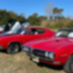 Lineup of vintage red muscle cars on display during the Hot Rods & Hayrides event at Rea’s Farm in Cape May.