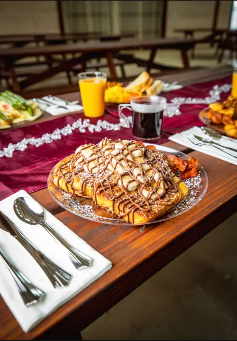 Cinnamon swirl French toast topped with icing and served with bacon, part of the seasonal breakfast menu at Rea’s Farm Market