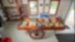 Rustic wooden wagon filled with fresh seasonal produce, breads, and farm goods inside Rea’s Farm Market in West Cape May.