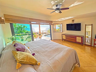 master bedroom with ocean views and direct access to swimming pool and overlook