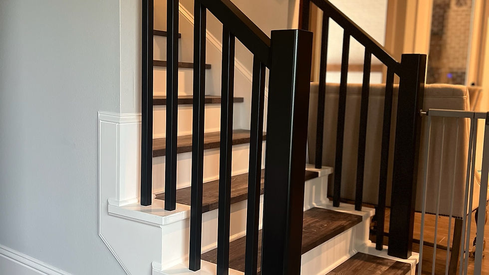 Modern, sleek staircase design featuring contrasting dark handrails and balusters with light steps.