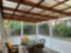 Screened in porch with CoverYourPergola roof system. PVC wrapped and stained.