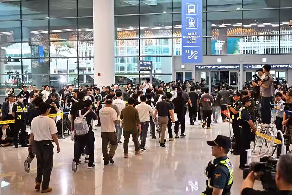 South Korean workers arrive at Incheon International Airport in South Korea on Friday.Anthony Wallace / AFP via Getty Images