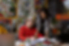 Woman Consulting a Man in an Artistic Space