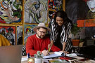 Woman Consulting a Man in an Artistic Space