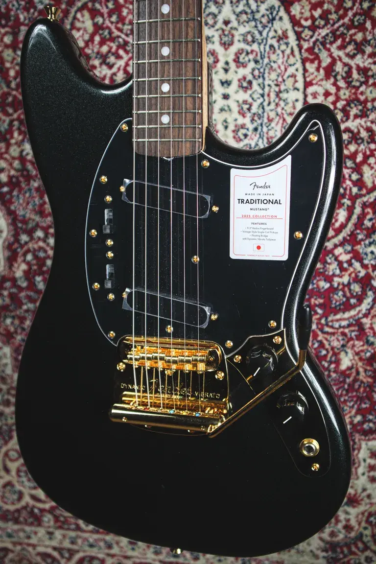 Thumbnail: Fender Mustang pickguard with factory sticker close-up