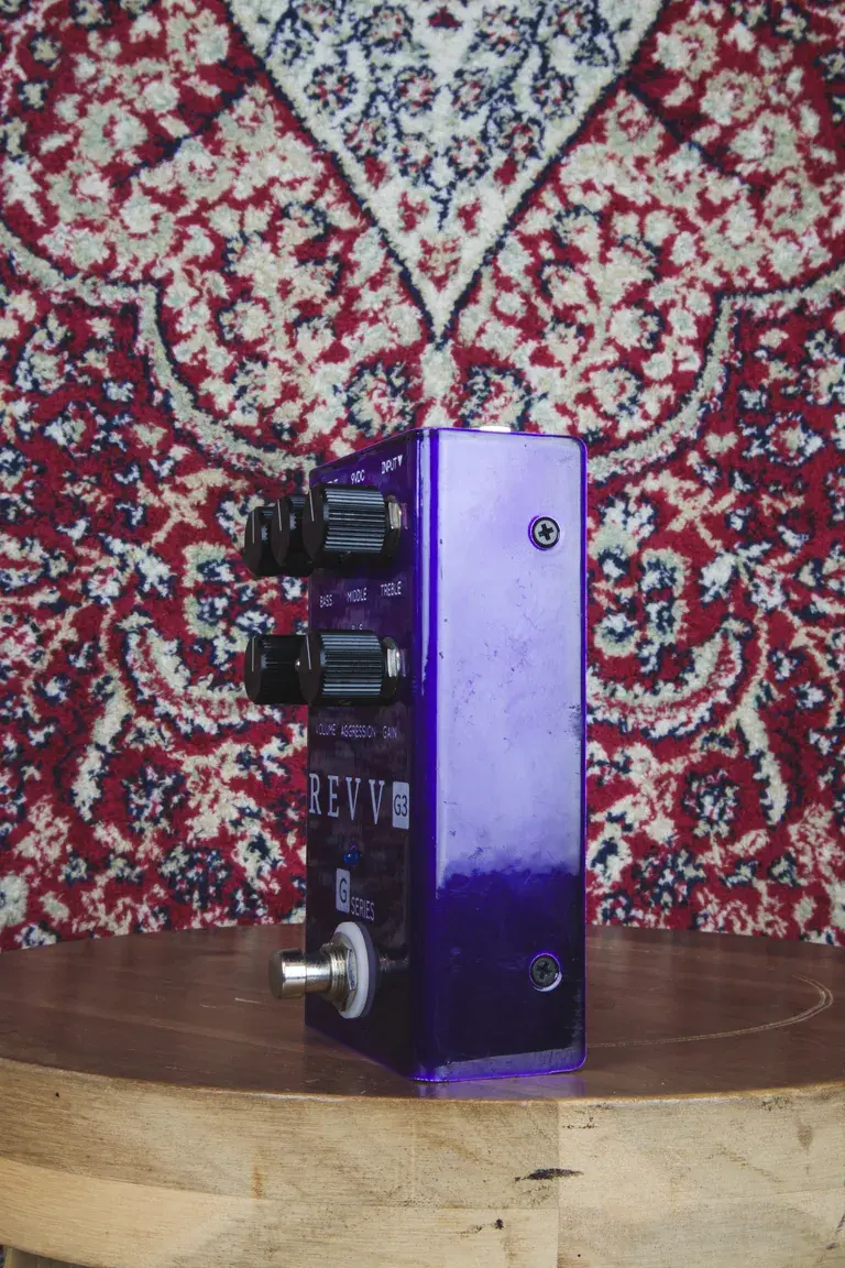 Side angled view of REVV G3 Distortion Pedal showing control knobs and jack input