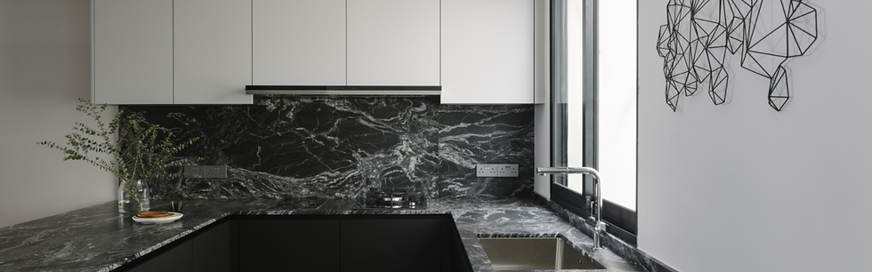 Modern kitchen with black marble countertops and backsplash