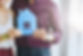 casually-dressed-unrecognizable-couple-hugging-and-posing-with-paper-cutout-of-house.jpg