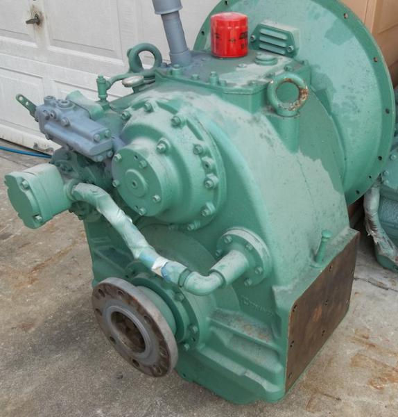 Angled workshop photograph of a heavy-duty green cast iron Tonanco marine transmission gearbox or power take-off (PTO) drive assembly resting on a concrete floor during maintenance.