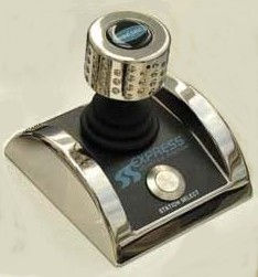 Close-up workshop view of an electronic marine maneuvering joystick controller showcasing its chrome casing and precision control layout.