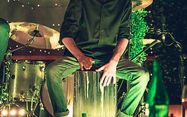 The Sound Board of Australia Founder Murray Jenkins plays percussive cajon with title entertainment in front.