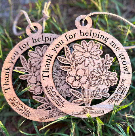Two Teacher ornaments with flowers engraved and Thank you for helping me grow on the ornament. Customized with school, grade, and signed with child's name.