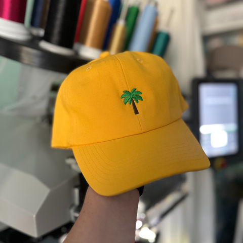 embroidered icon on a yellow dad cap baseball hat