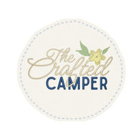 The crafted camper logo with embroidered flower and script font 