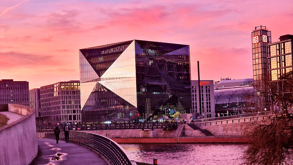 The violet-pink sunset bathes the museum in color and makes it shine unrealistically.