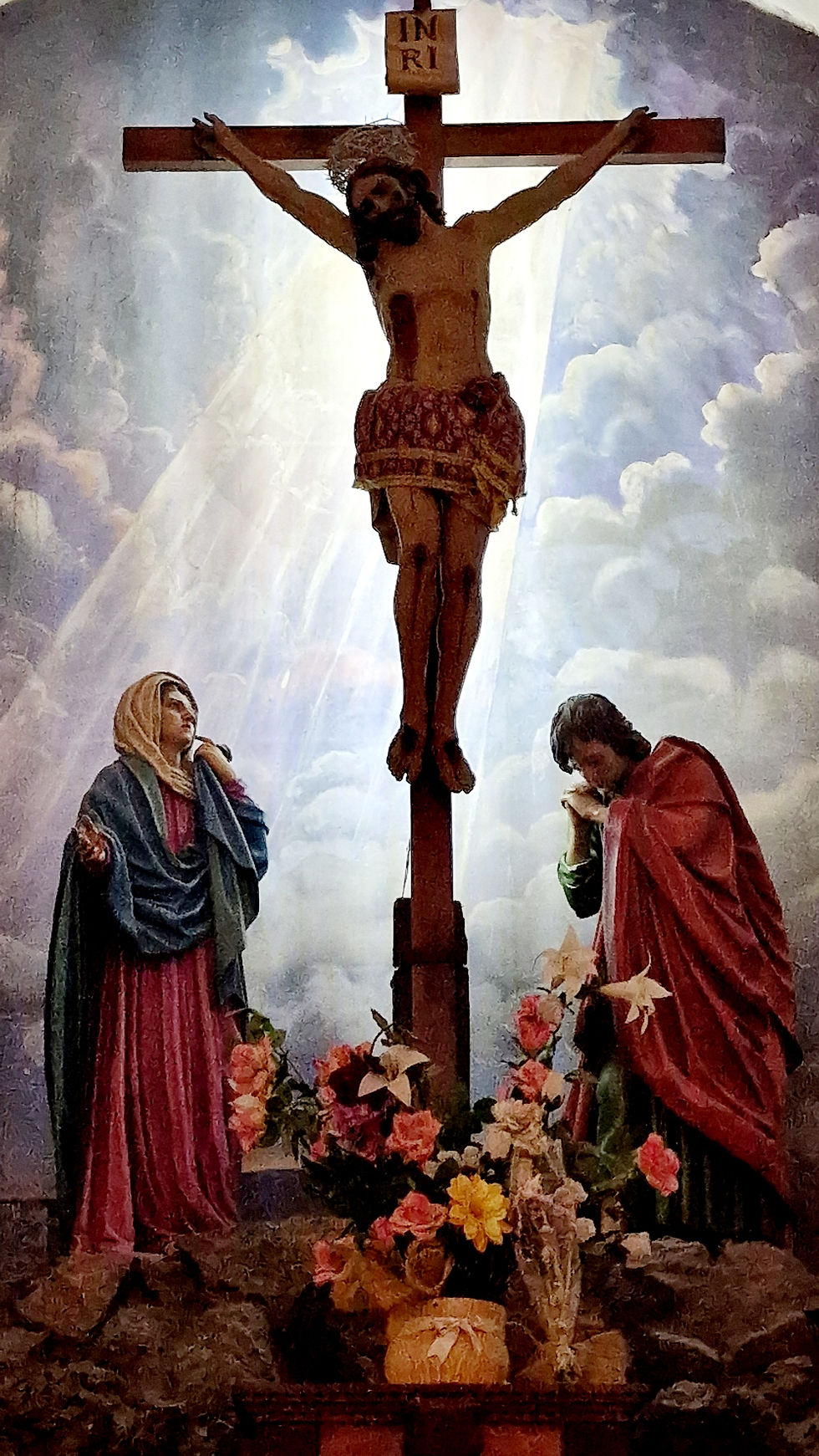 Bild des am Kreuz hängenden toten Jesus Christus. Davor eine wehklagende Frau und ein Mann.
