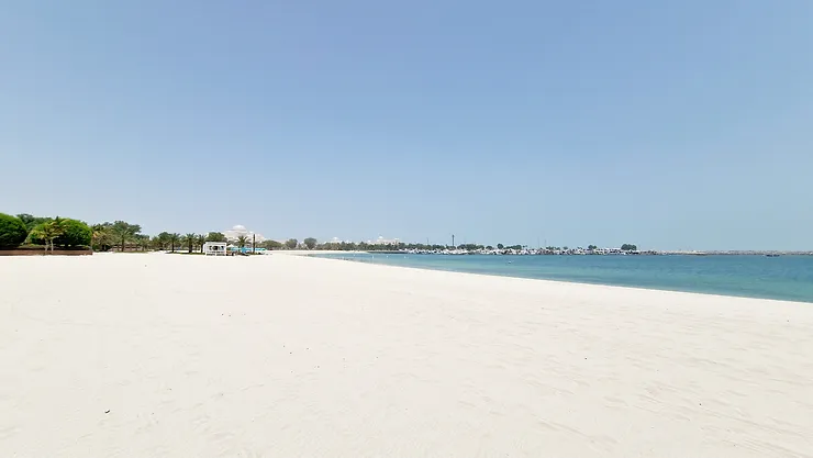 White deserted sandy beach and crystal clear water.