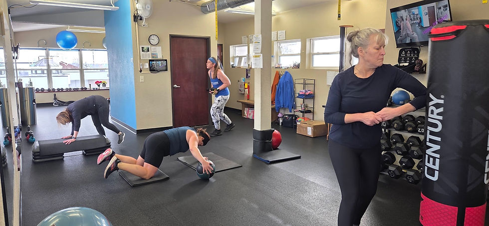 High angle view of a fitness trainer guiding a small group through mobility exercises