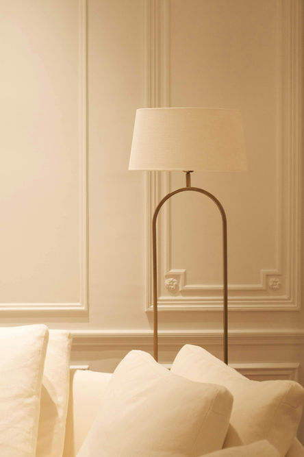 Elegant arc floor lamp beside cream sofa
