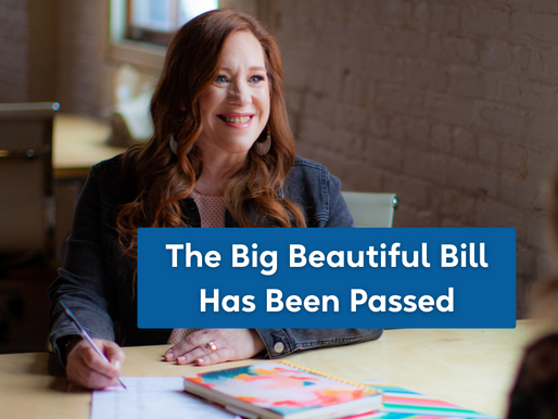 Leanne sitting at a desk writing with the title of the blog The Big Beautiful Bill Has Been Passed in white lettering with a blue background
