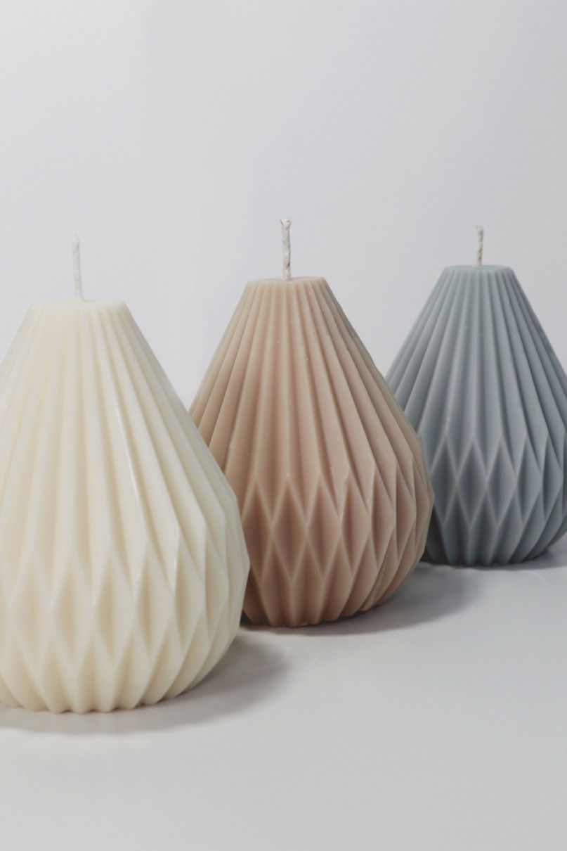 lantern shaped candles in three different colours decorative candles structural sculptural architechtural