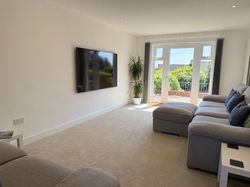 Living Room with 75" TV and large comfy sofas